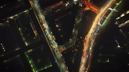 Birds Eye Ascending Shot of Cars Driving in Evening Streets in Urban Borough Fly Above Metropolis at