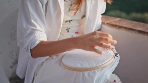 Woman Hand Inserting Needle Embroider at Balcony Closeup Lady Crossing Stitches