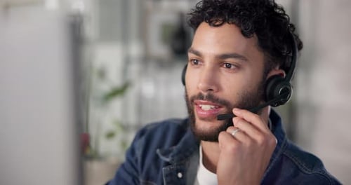 Young Adult Man On Headset Talking From Home