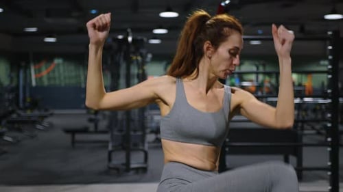 Athletic Beautiful Woman in the Gym Doing Sports Motivational Exercises to Keep Body and Mind