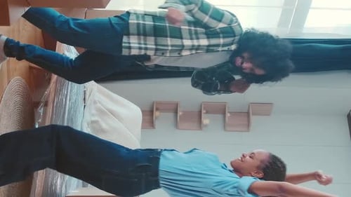 Cheerful Couple Dancing While Moving Into New Home