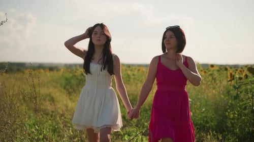 Friends Walk Sunshine Two Women Laugh in Field Joyful Ladies Stroll Through Blooming Sunflowers Two