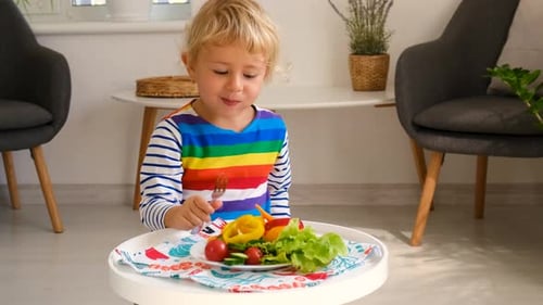 Child Eating a Healthy Salad in a Bright Home