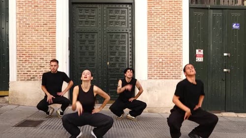 Group of Dancers Performing Synchronized Choreography on Street