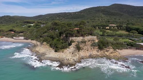 Aerial view of coastline and green hills, Italy.