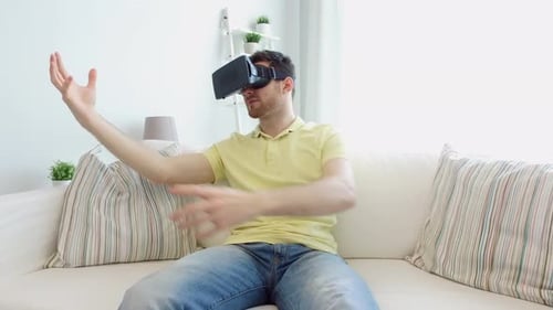 Man Experiences Virtual Reality Headset on Living Room Couch