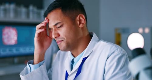 Stressed Scientist Experiencing Headache in Lab