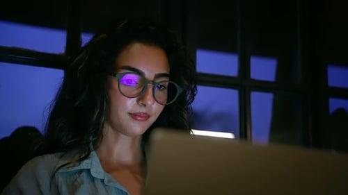 Woman Works at Laptop Computer Late at Night