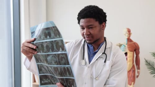 Expert Examining CT Images in Office of Outpatient Clinic