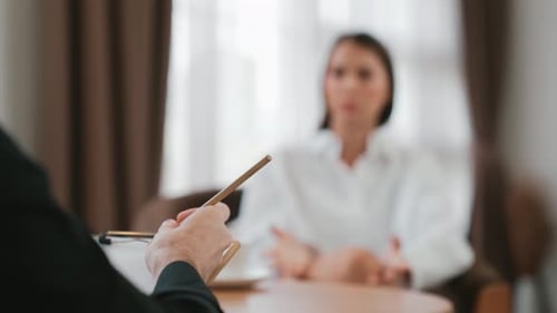 Woman Talking with a Man Holding a Notepad