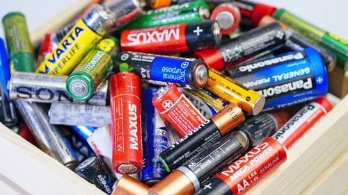 Used Batteries in Wooden Box Close Up