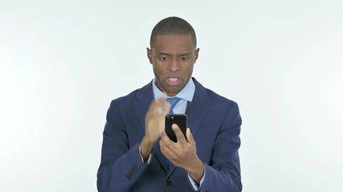 Young Adult Reacts with Shock to Mobile Phone
