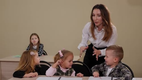 A Kind Teacher Helps Young Children During Elementary School Classes