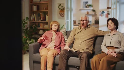Seniors Chatting on Couch in Living Room