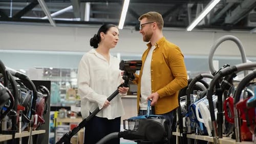 Woman Explains Vacuum to Man in Appliance Store