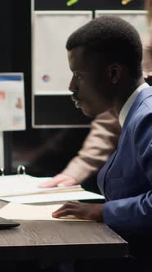 Corporate Team Reviewing Documents at Desk