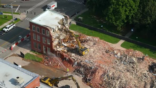 Building Demolition Site with Hydraulic Crusher Excavator Tearing Down Brick Walls of Old Built