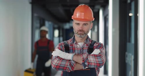 A Construction Worker Wearing a Helmet Diligently Working on a Construction Site Today