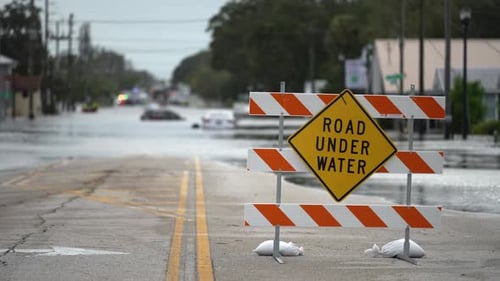 Hurricane Debby Flooded Street with Road Closed Sign Blocking Driving of Cars in Sarasota Florida