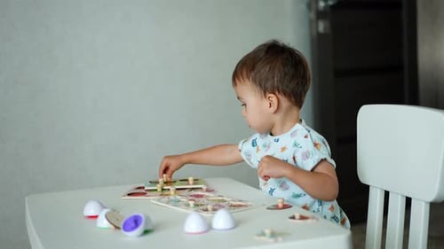 Year and half toddler playing with puzzles. Lovely kid studying through a game.