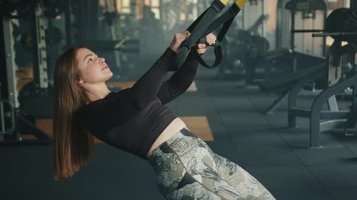 Woman Doing Suspension Strap Workout at Gym