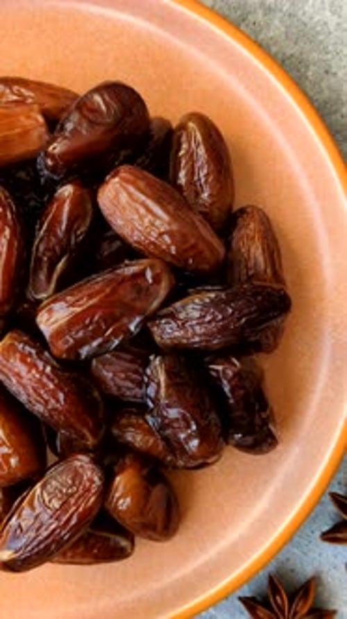 Dried dates on a ceramic plate for Ramadan or Iftar. Dates fruit as a background