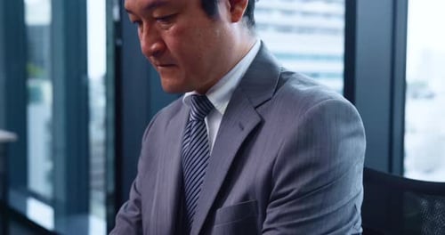 Japanese businessman, laptop and typing in office with documents, report and research in corporate