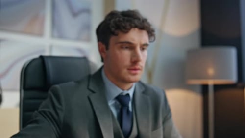 Professional Man Typing on Laptop in Office