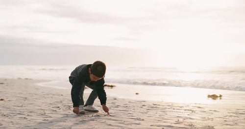 Boy, drawing and heart in sand, beach and playful game for art, vacation and nature in sunshine