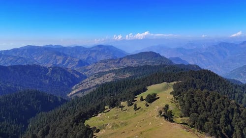 drone video of himachal mountains range with lush green forest and sky