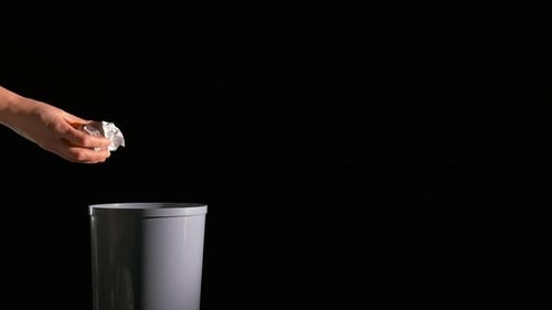 Throw Paper Balls in Bin on Black Background