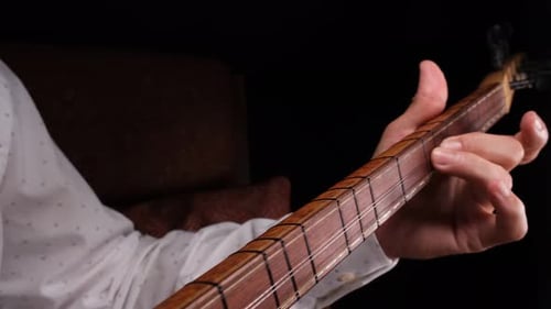 Hand Plays Traditional Stringed Instrument Close Up