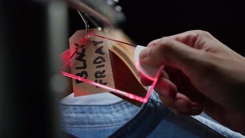 Scanning Black Friday Tag in Clothing Store