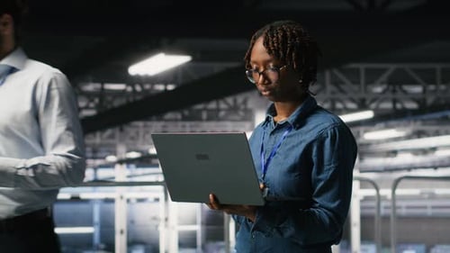 Data Center System Administrators Doing Maintenance Tasks on Laptop
