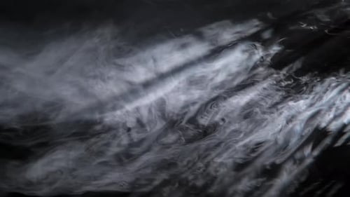Cinematic light rays with smoke in the air and atmosphere for overlay on a black background