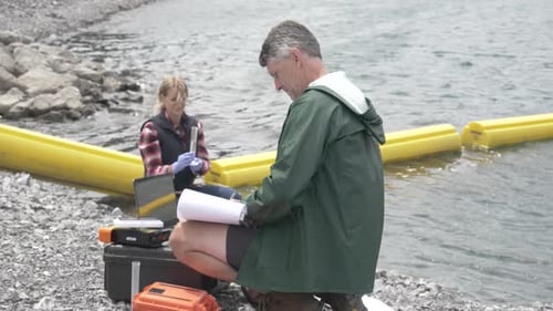 Ecologists with Equipment Testing Lake Water Samples Adult