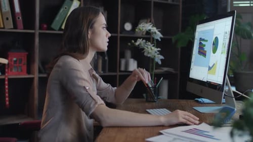 Focused Business Woman Working on Computer at Home Office. Concentrated Businesswoman Analyzing