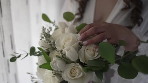 Close Up of Woman Holding a White Floral Bouquet