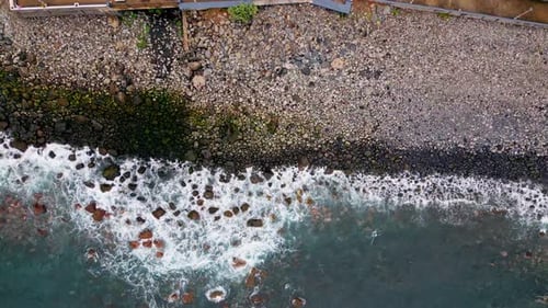 Aerial Foamy Waves Rolling on Stone Shoreline Beautiful Ocean Water Splashing