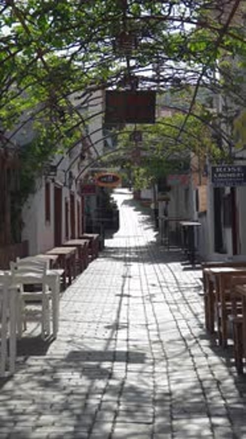 Vertical of Cozy Street Cafes with Wooden and Plastic Tables in Town