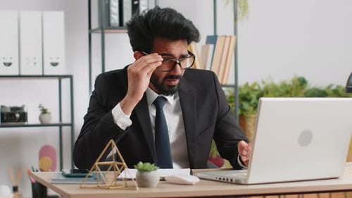 Tired Indian Business Man Suffering From Headache Problem Tension Migraine Stress at Home Office