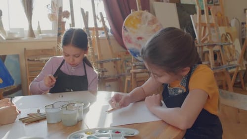 Children Drawing at a Table in Art Classroom