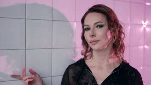 Woman with Make Up Posing by Tiled Wall