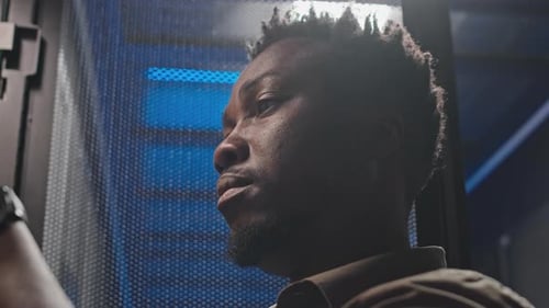 Thoughtful Young Adult Works in Server Data Center