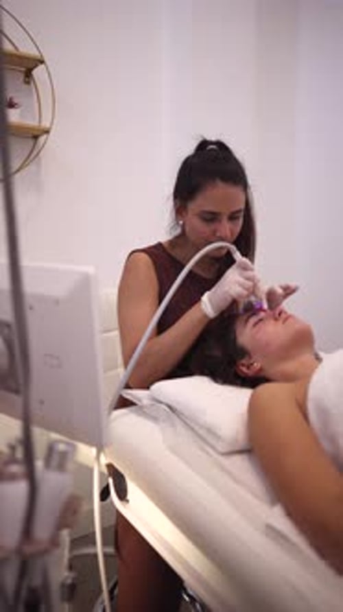 Woman Receives a Facial Treatment at Beauty Salon