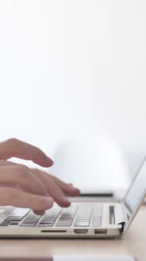 Close Up of Male Hands Typing on Laptop, Side View, Vertical Video