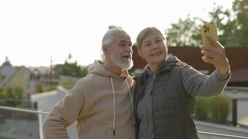 Happy Senior Couple in Love Doing Selfie Standing in the Park