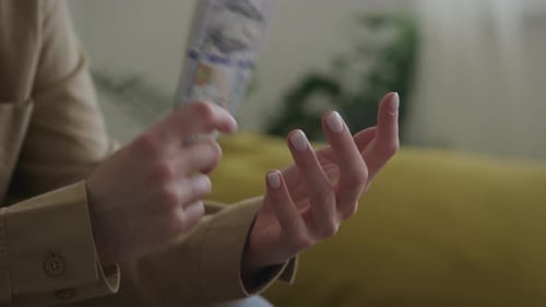 Counting Money in Hands Indoors During Daytime