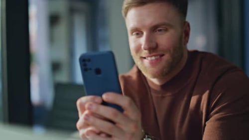 Smiling Man Holding Smartphone in Home Office Closeup Businessman Using Phone