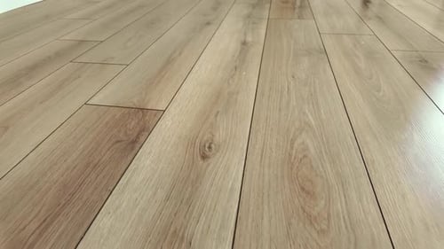 Smooth Camera Movement Across Light Brown Laminate Flooring